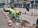 工人正在修复人行道面砖。青羊区委宣传部 供图 - Sc.Chinanews.Com.Cn
