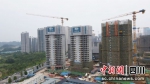 项目首栋住宅楼主体结构封顶。十九冶供图 - Sc.Chinanews.Com.Cn