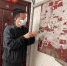 当地一名乱贴小广告人员正在清理“牛皮癣”广告。 - Sc.Chinanews.Com.Cn